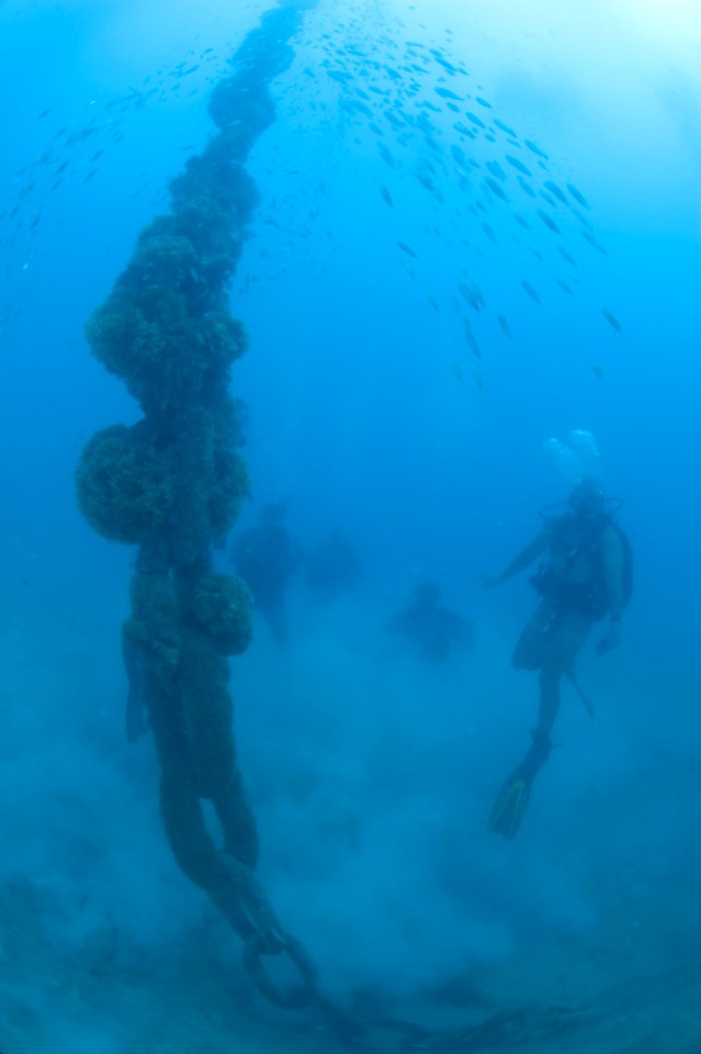 US Navy 100614-N-1134L-011 Navy Diver 2nd Class Jason Hatch, assigned to Mobile Diving and Salvage Unit (MDSU) 2, and Regional Security Service divers visually inspect the anchor chain of a mooring buoy