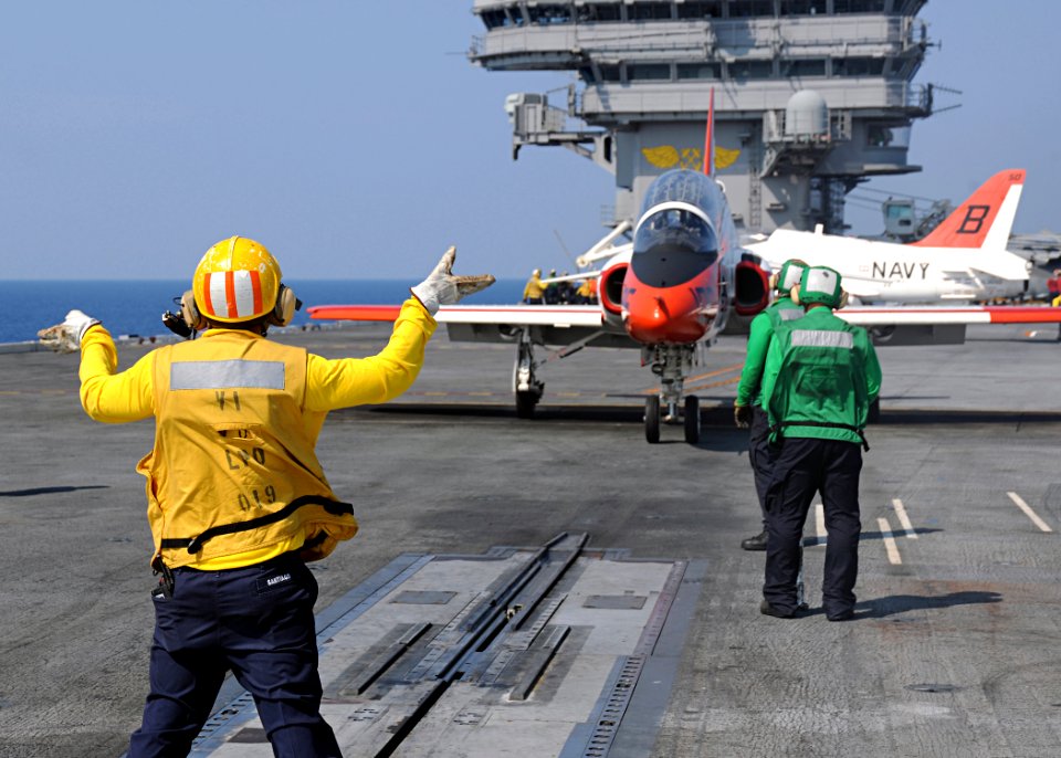 US Navy 100613-N-3885H-158 A Sailor directs a T-45A Goshawk as it prepares for launch from USS George H.W. Bush (CVN 77)