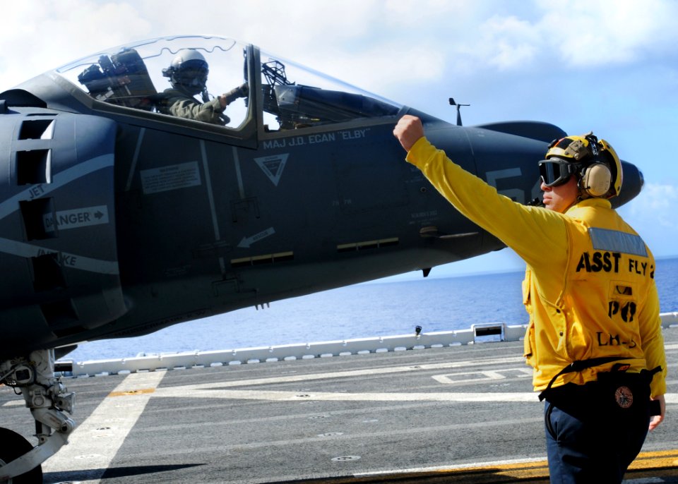 US Navy 100611-N-1226D-442 Aviation Boatswains Mate (Handling) 2nd Class Victor Estevez checks the trim on an AV-8B Harrier