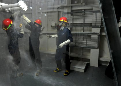 US Navy 100610-N-7643B-231 Sailors from the guided-missle frigate USS Vandegrift (FFG 48) patch a pipe in the damage control wet trainer