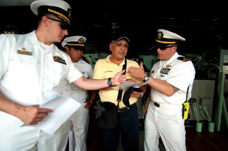 US Navy 100615-N-5319A-011 Sailors explain to a harbor pilot how they would like to maneuver the amphibious transport dock ship USS New Orleans (LPD 18) into port