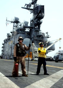 US Navy 100610-N-8936G-102 Lance Cpl. Matthew Canon, left, from Virginia Beach, Va., and Aviation Boatswain's Mate (Handling) Airman Samuel Meza, from Bronx, N.Y., stand by with a fire extinguisher