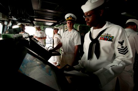 US Navy 100615-N-5319A-001 Quartermaster 1st Class Martez Smith mans the radar as Sailors from the Mexican navy watch on the bridge of the amphibious transport dock ship USS New Orleans (LPD 18) while arriving in Manzanillo, Me