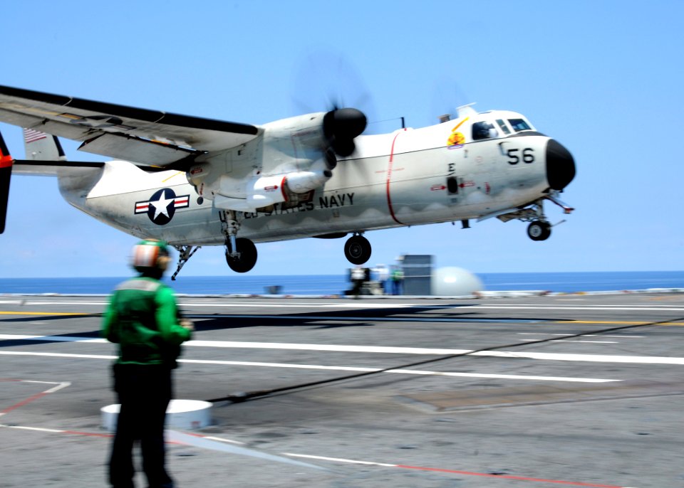 US Navy 100612-N-7908T-054 A Sailor watches a C-2A Greyhound land aboard USS George H.W. Bush (CVN 77)