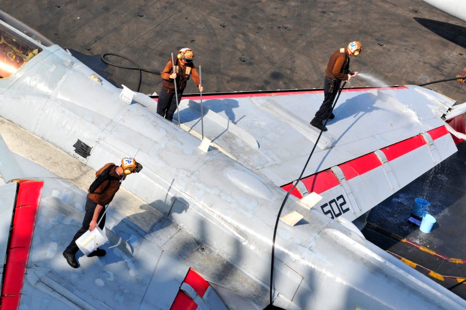 US Navy 100612-N-3595W-004 Sailors assigned to the Patriots of Electronic Attack Squadron (VAQ) 140, clean an EA-6B Prowler on the flight deck of the aircraft carrier USS Dwight D. Eisenhower (CVN 69)