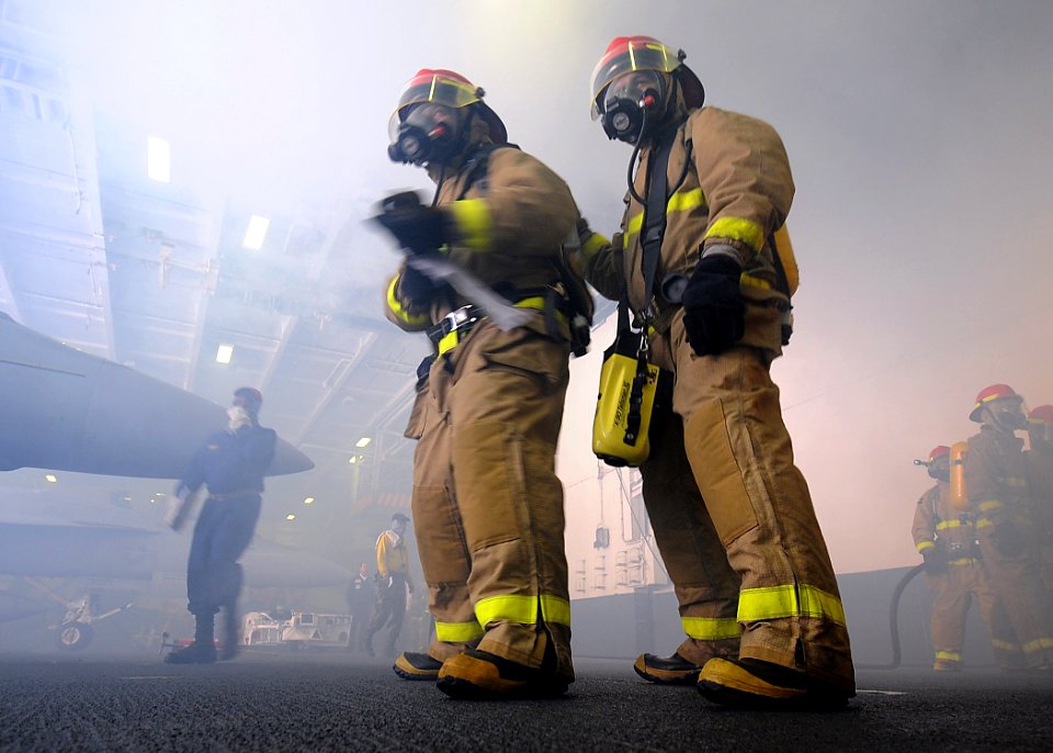 US Navy 100615-N-7191M-031 Yeoman Seaman Jamie Hernandez, left, from El Paso, Texas, and Personnel Specialist 2nd Class William Rivera, from Jersey City, N.J., fight a simulated fire during a general quarters drill