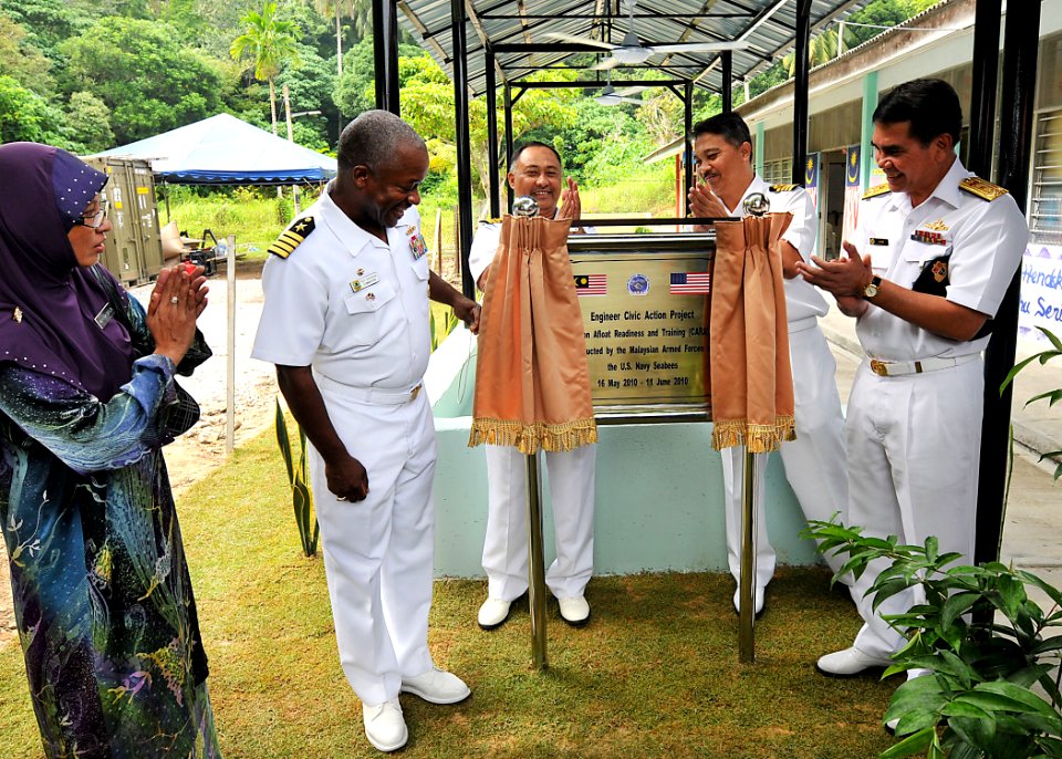 US Navy 100611-N-7643B-150 Capt. Richard Clemmons, left, commodore of Task Group 73.1, helps unveil a dedication marker in front of the Sekolah Kebangsaan Lumut school