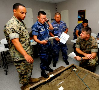 US Navy 100615-N-9643W-230 Sgts. Juan Martinez and Edan Valkner evaluate a 3D-model terrain with members of the Nicaraguan military during a subject matter expert exchange