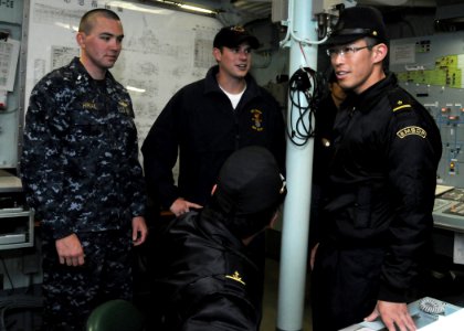 US Navy 100616-N-3327M-003 Lt. j.g. Chris Hiriak and Lt. j.g. Carter Stapleton, visit the damage control center of the Japan Maritime self-Defense Force guided-missile destroyer JDS Atago (DDG 177)