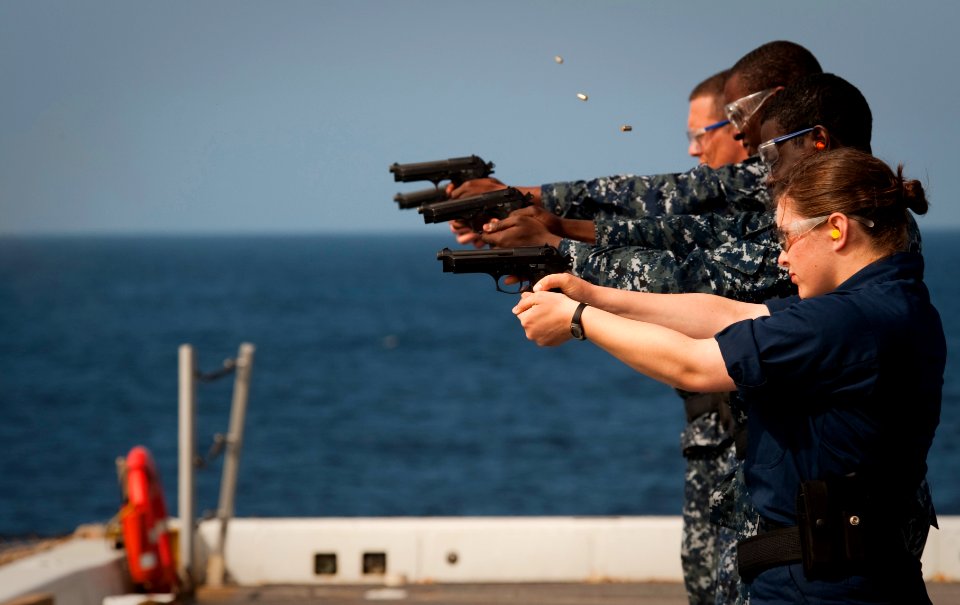 US Navy 100612-N-5319A-071 Sailors aboard the amphibious transport dock ship USS New Orleans (LPD 18) fire 9mm small arms on the flight deck during qualification trials