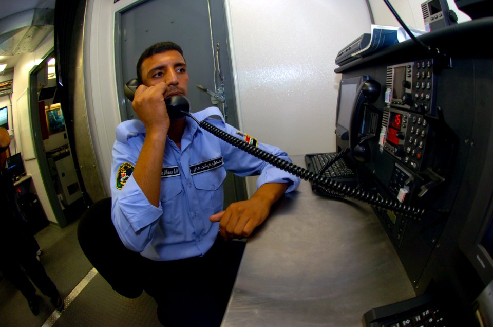 US Navy 100616-N-4482V-003 An Iraqi sailor passes information to the crew while training inside a full mission bridge trainer during a 90-day operations and maintenance training program in Morgan City, La