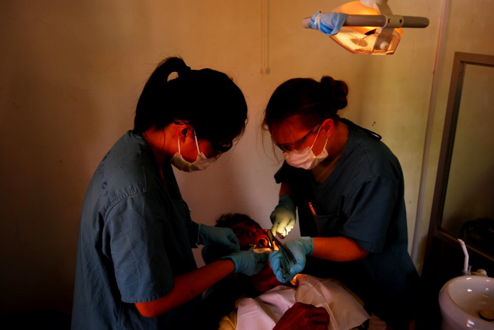 US Navy 100616-N-5207L-051 Jennifer Tran and Maj. Joanna Jaminska extract a tooth from a Cambodian patient during a Pacific Partnership 2010 dental civic action program