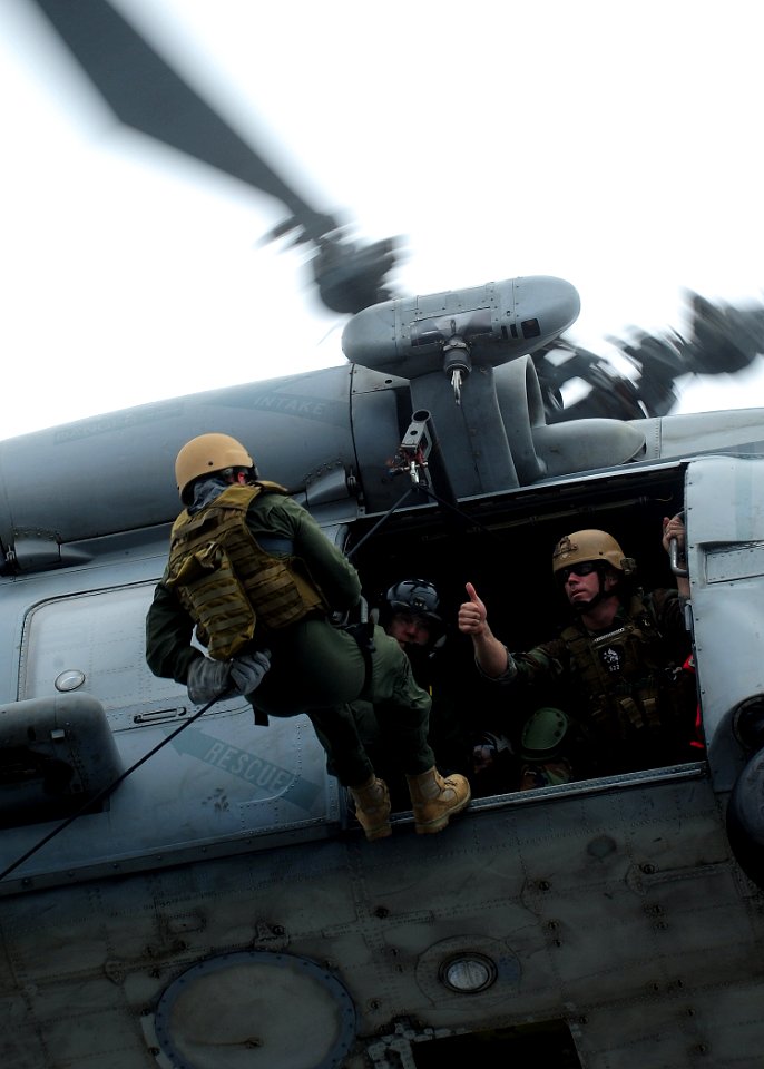 US Navy 100616-N-6720T-098 Explosive Ordnance Disposal Technician 2nd Class Daniel Dopler gives the thumbs up signal to Navy Diver 2nd Class Preston Kopcsik while conducting helicopter rope suspension training