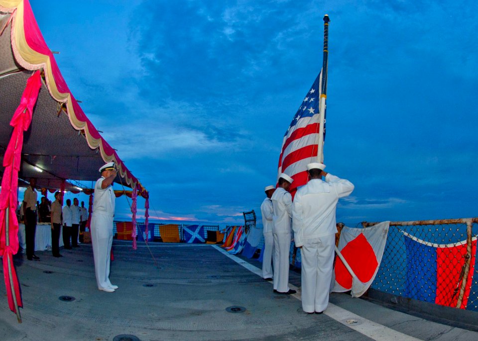 US Navy 100614-N-6770T-870 Sailors and Marines observe colors aboard the amphibious dock landing ship USS Tortuga (LSD 46)