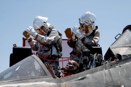 US Navy 100614-N-6552M-047 Aviation Boatswain's Mates (Handling) Airman Christopher Head and Matthew Bigelow communicate with the flight deck