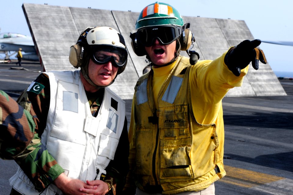 US Navy 100614-N-6604E-119 Lt. Christopher Dirkschneider explains aircraft carrier flight operations to Pakistani navy Rear Adm. Zafar Mahmood Abbasi