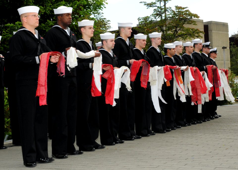 US Navy 100614-N-4649C-002 Sailors from Trident Training Facility (TTF) hold strips of 14 American flags ready to be burned during a flag retirement ceremony at Naval Base Kitsap, Wash