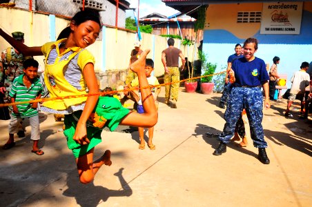 US Navy 100617-N-6597H-165 A Cambodian child plays jump rope with a Sailor from the Military Sealift Command hospital ship USNS Mercy (T-AH 19) photo