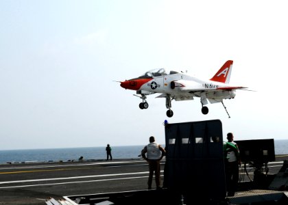 US Navy 100614-N-7908T-205 Landing signal officers watch a T-45A Goshawk training aircraft land aboard USS George H.W. Bush (CVN 77)