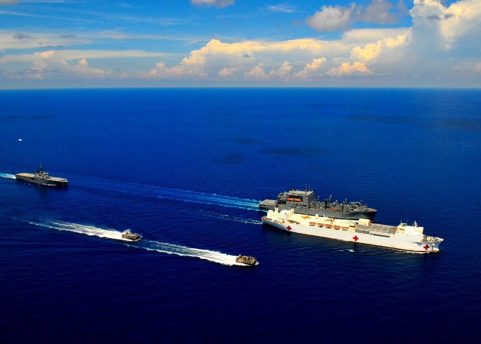 US Navy 100614-N-6597H-394 The Military Sealift Command hospital ship USNS Mercy (T-AH 19), center, the Military Sealift Command dry cargo ammunition ship USNS Amelia Earhart (T-AKE 6)
