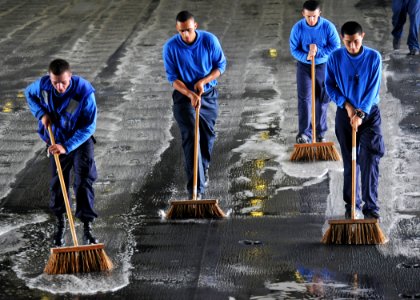US Navy 100614-N-8913A-024 Sailors perform a scrubbing exercise in the hangar bay aboard SS George H.W. Bush (CVN 77)
