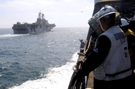 US Navy 100617-N-7058E-122 Chief Boatswain's Mate Franscisco Valdovinos watches as Freedom approaches the amphibious assault ship USS Bonhomme Richard (LHD 6)