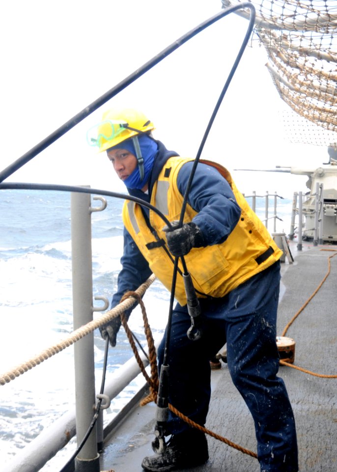 US Navy 100615-N-3327M-042 Boatswain's Mate 3rd Class James Nanca, from Sacramento, Calif., prepares for a replenishment at sea with the Military Sealift Command fleet replenishment oiler USNS Guadaloupe (T-AO 200)