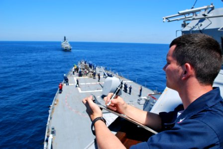 US Navy 100618-N-2653R-309 Quartermaster 3rd Class Jesse Alcorn marks speed and course changes called out from the conning officer of the guided-missile destroyer USS Barry (DDG 52)