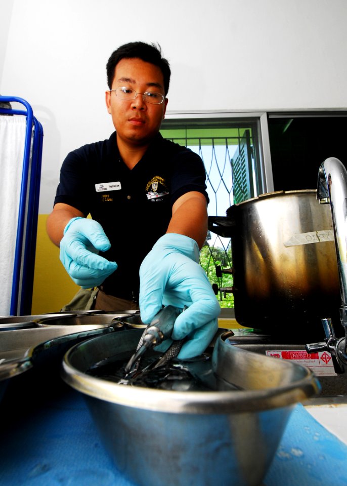 US Navy 100616-N-4044H-291 Tom Lam cleans dental instruments during a Pacific Partnership 2010 dental civic action program