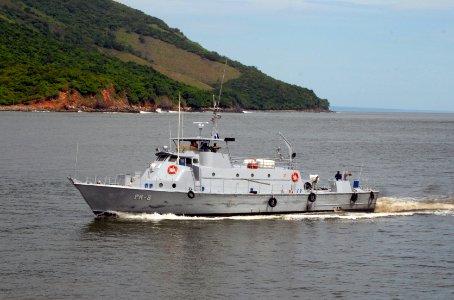 US Navy 100618-N-4971L-003 A patrol boat escorts High Speed Vessel Swift (HSV 2) as it arrives for a port visit