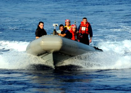 US Navy 100615-N-7908T-107 A rigid-hull inflatable boat returns to USS George H.W. Bush (CVN 77) following man overboard recovery drills