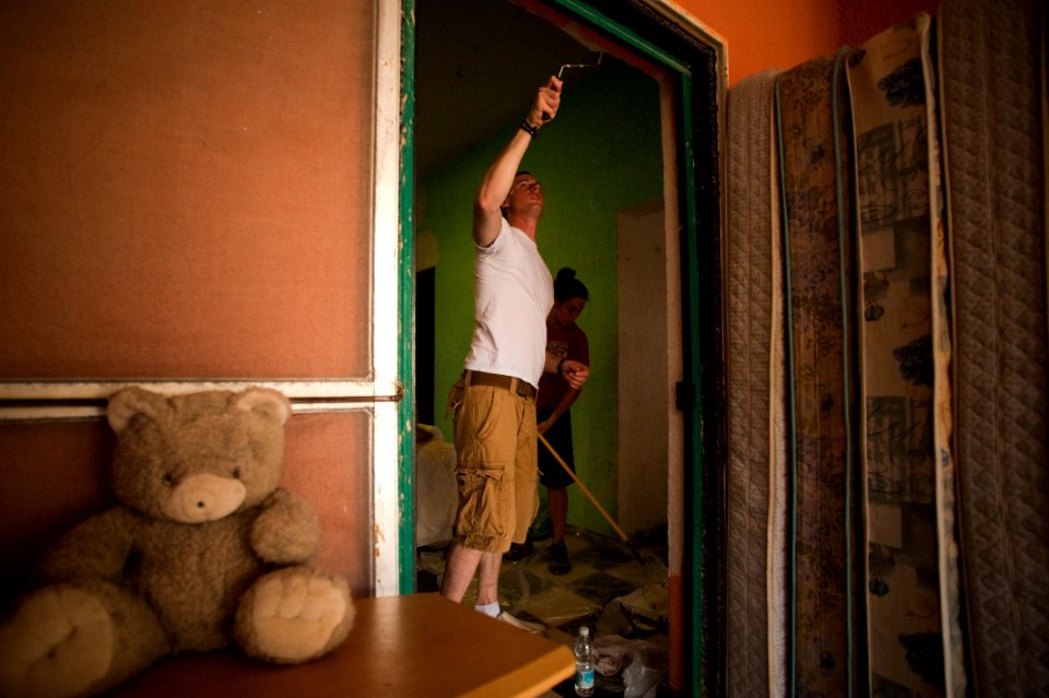 US Navy 100617-N-5319A-068 Sailors and Marines embarked aboard the amphibious transport dock ship USS New Orleans (LPD 18) paint an orphanage during a community service project