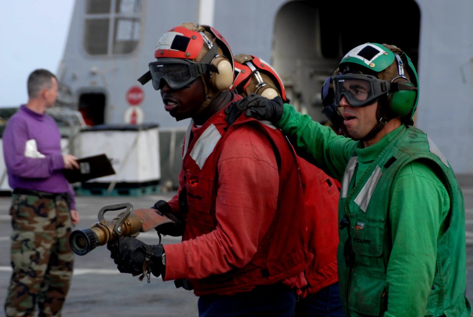 US Navy 100619-N-3358S-009 Hose team leader Aviation Support Equipment Technician 3rd Class Peoro Amieva, right, from Gijan, Spain