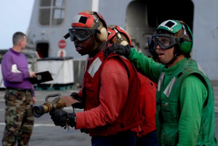 US Navy 100619-N-3358S-009 Hose team leader Aviation Support Equipment Technician 3rd Class Peoro Amieva, right, from Gijan, Spain
