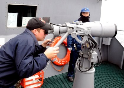US Navy 100616-N-3327M-009 Lt. j.g. Carter Stapleton watches passing ships aboard DS Atago (DDG 177)