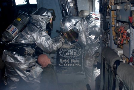 US Navy 100619-N-3358S-024 Sailors perform a simulated rescue inside a CH-53E Super Stallion helicopter during a fire drill aboard the amphibious transport dock ship USS Mesa Verde (LPD 19) photo