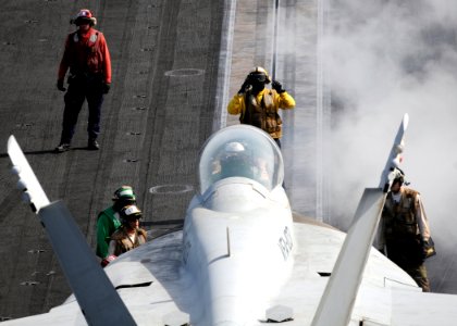 US Navy 100616-N-4236E-275 viation Boatswain's Mate (Handling) 2nd Class Bryant Simms directs an F-A-18F Super Hornet