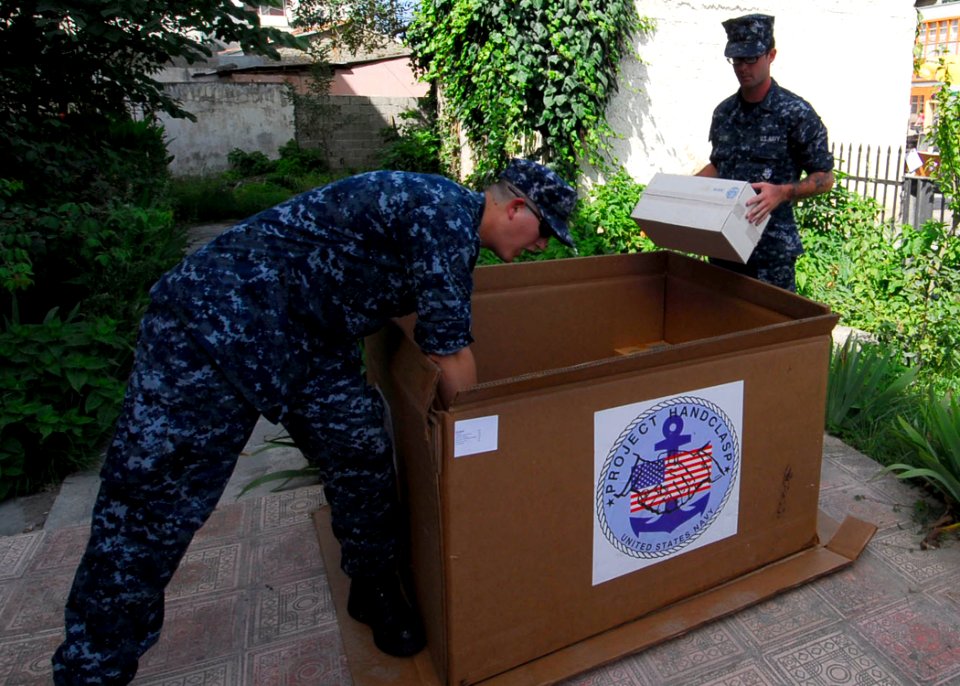 US Navy 100617-N-7638K-067 Sailors assigned to the guided-missile frigate USS Taylor (FFG 50) unload boxes of donated supplies from Project Handclasp to the Ledi Diana Pediatric Clinic