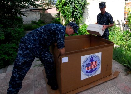 US Navy 100617-N-7638K-067 Sailors assigned to the guided-missile frigate USS Taylor (FFG 50) unload boxes of donated supplies from Project Handclasp to the Ledi Diana Pediatric Clinic