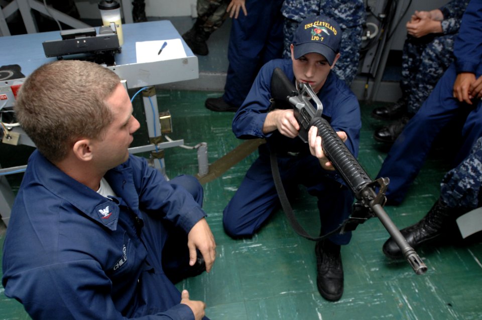US Navy 100619-N-6477M-030 Ship's Serviceman Seaman Craig Parker receives hands-on weapons familiarization training with an M-16 rifle from Gunner's Mate 3rd Class Seth Childers