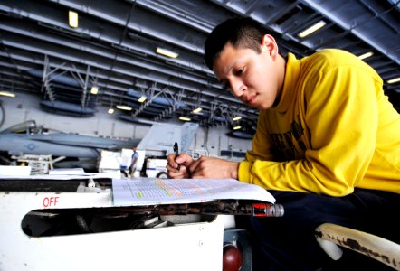 US Navy 100616-N-6003P-098 Aviation Boatswain's Mate (Handling) 3rd Class Ray Amaya, studies for his Enlisted Aviation Warfare Specialist exam during a break aboard the Nimitz-class aircraft carrier USS Harry S. Truman (CVN 75)