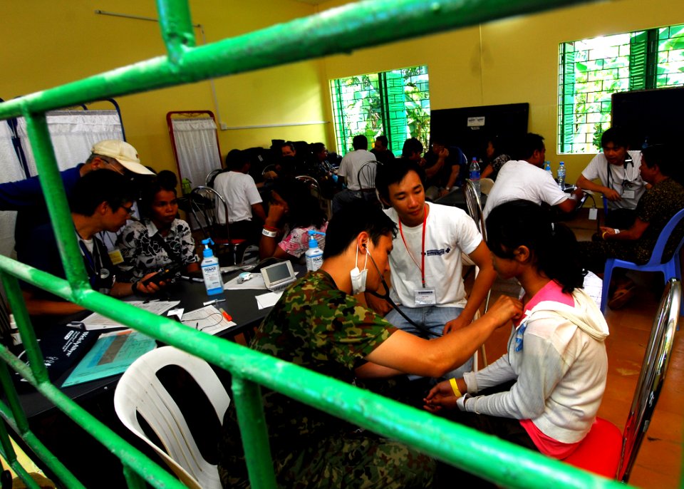US Navy 100616-N-4044H-051 1st Lt. Motonori Shimizu listens to the heartbeat of a Cambodian child during a Pacific Partnership 2010 medical civic action program
