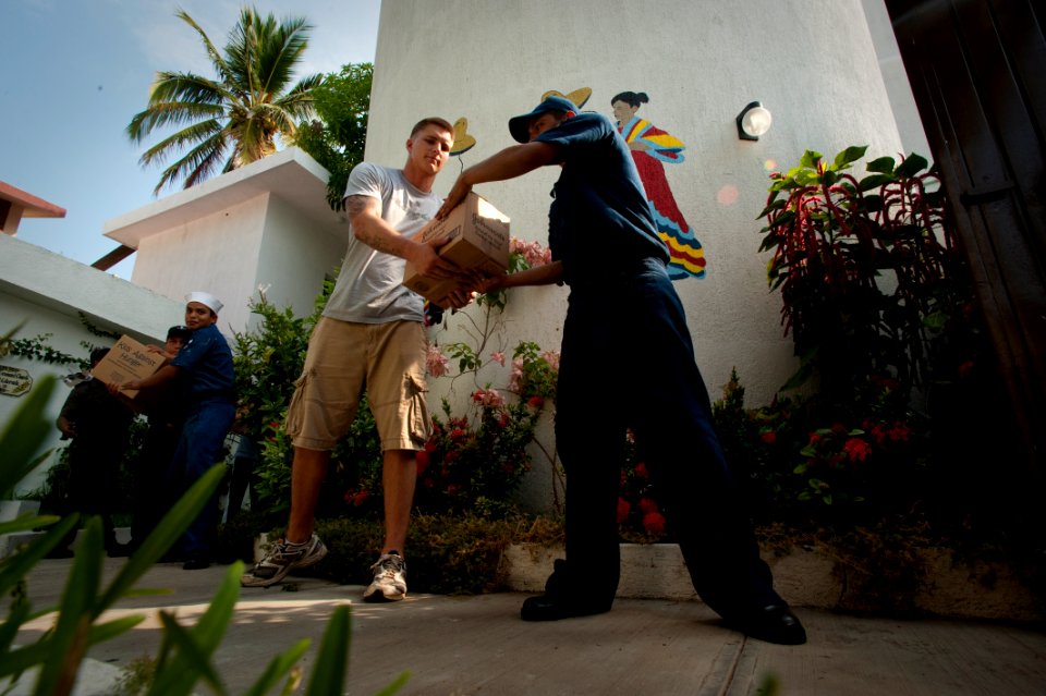 US Navy 100617-N-5319A-046 Sailors and Marines assigned to the amphibious transport dock ship USS New Orleans (LPD 18) and Mexican sailors off-load supplies from Project Handclasp during a community service project