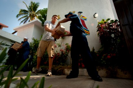 US Navy 100617-N-5319A-046 Sailors and Marines assigned to the amphibious transport dock ship USS New Orleans (LPD 18) and Mexican sailors off-load supplies from Project Handclasp during a community service project