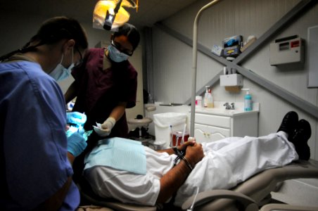 US Navy 100617-N-7456N-157 The Joint Medical Group dental officer provides dental treatment to a detainee at the detention hospital at Joint Task Force Guantanamo photo