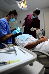 US Navy 100617-N-7456N-168 The Joint Medical Group dental officer provides dental treatment to a detainee at the detention hospital at Joint Task Force Guantanamo photo