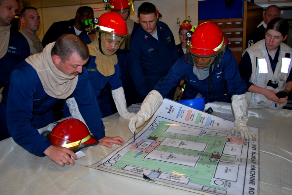 US Navy 100618-N-2653R-071 U.S. Sailors map out simulated damages on a diagram of the upper auxiliary machinery room aboard the Royal Navy frigate HMS Sutherland (F81)