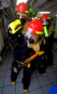US Navy 100621-N-4135M-222 Sailors aboard the aircraft carrier USS Harry S. Truman (CVN 75) battle a simulated fire during a general quarters drill