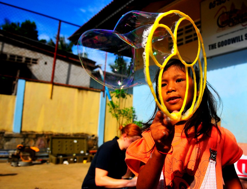 US Navy 100617-N-6597H-063 A Cambodian child plays with bubbles during a Pacific Partnership 2010 community service event at the Goodwill School involving personnel from the Military Sealift Command hospital ship USNS Mercy (T