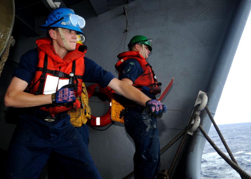 US Navy 100618-N-4830B-031 Boatswain's Mate 3rd Class Nathan Long, from San Diego, pulls across a line from the Military Sealift Command fleet replenishment oiler USNS Walter S. Diehl (T-AO 193)